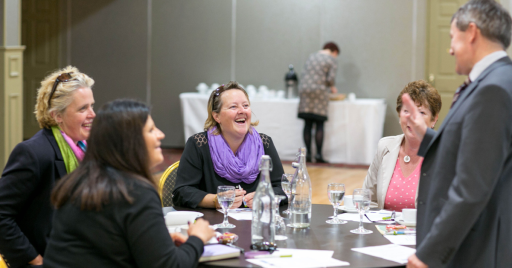 An image of a group of people networking at an event.