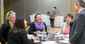 An image of a group of people networking at an event.