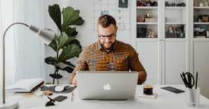 An image of a man working at a computer.